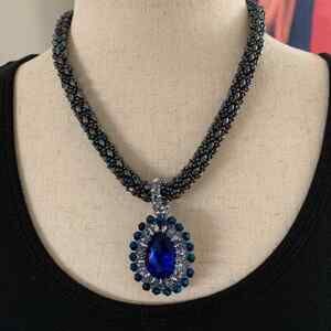 Handmade black Seed bead necklace with silver accents.bezeled oval blue crystal